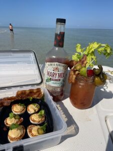 Custom Bloody Mary cocktail and deviled eggs served on a boat at a sandbar in Naples, Florida