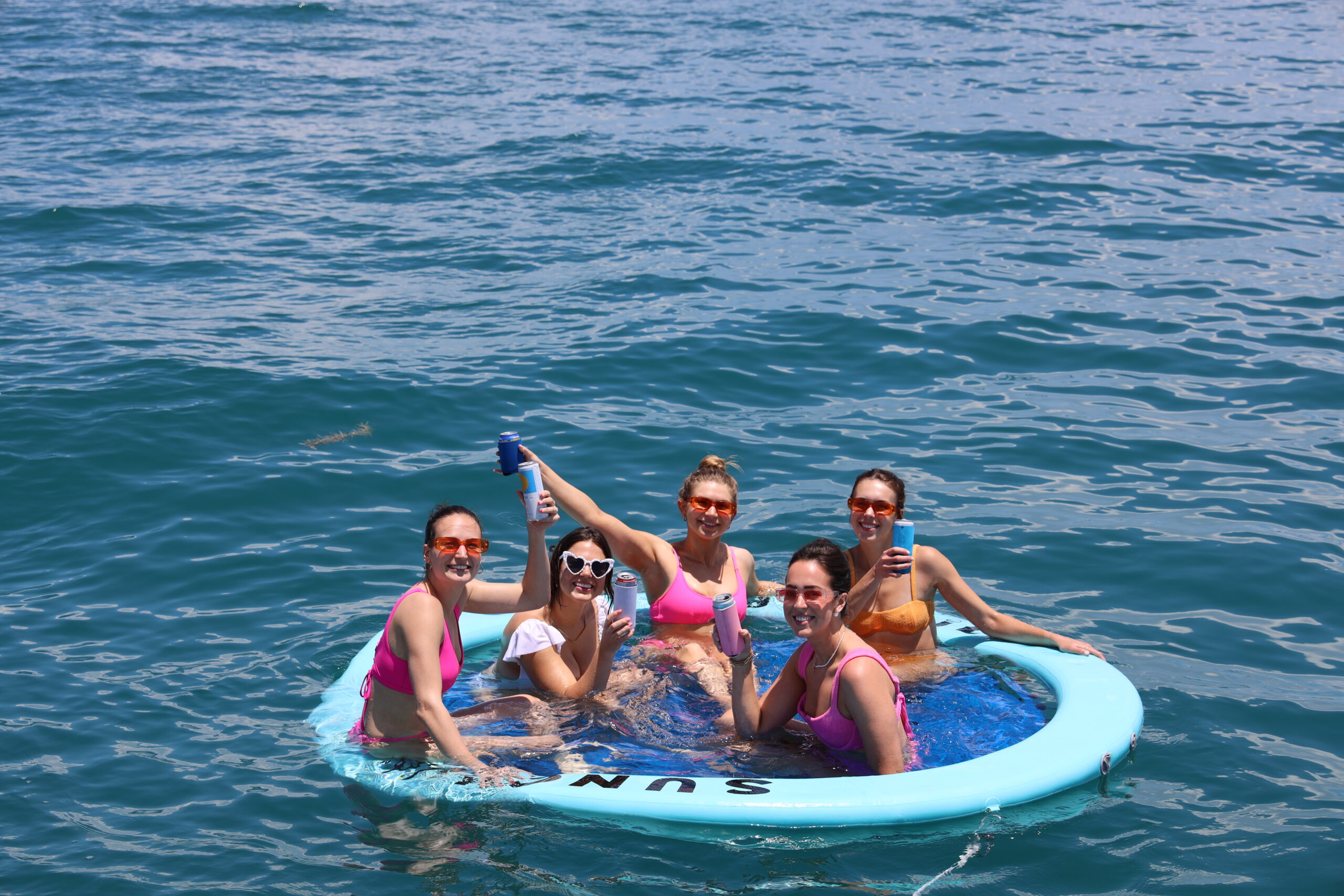 Family swimming off the coast of Naples, Florida during a Beach Club Charter with BRADventures yacht